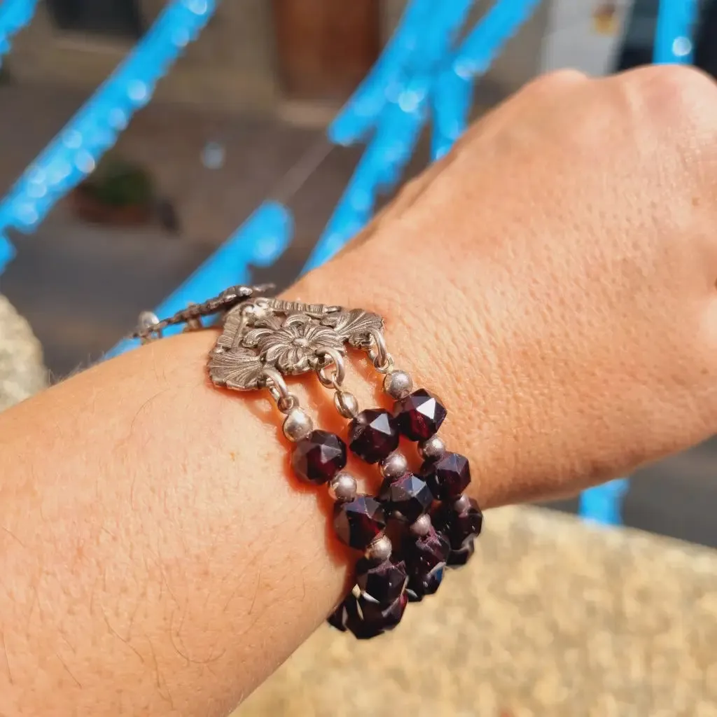 Antique silver modernist bracelet, floral motif and garnet glass beads.
