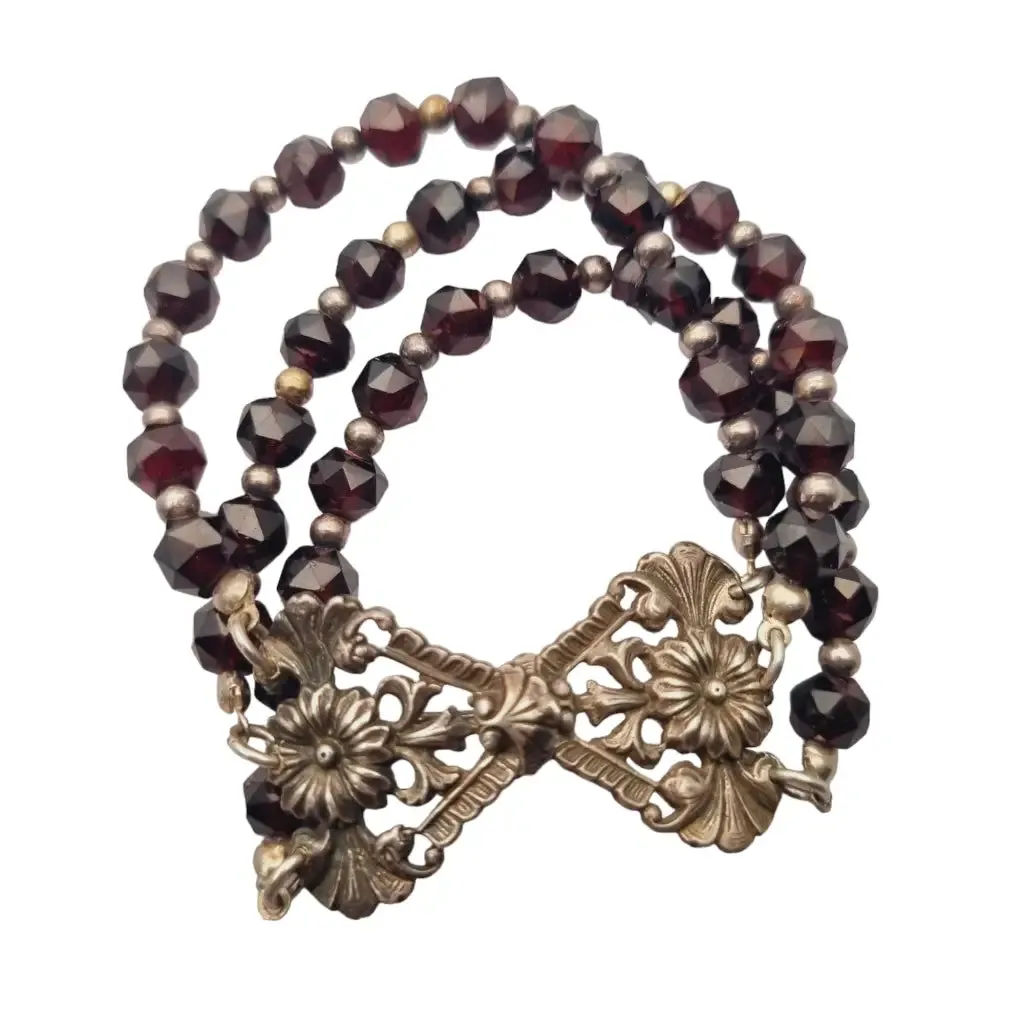 Antique silver modernist bracelet, floral motif and garnet glass beads.