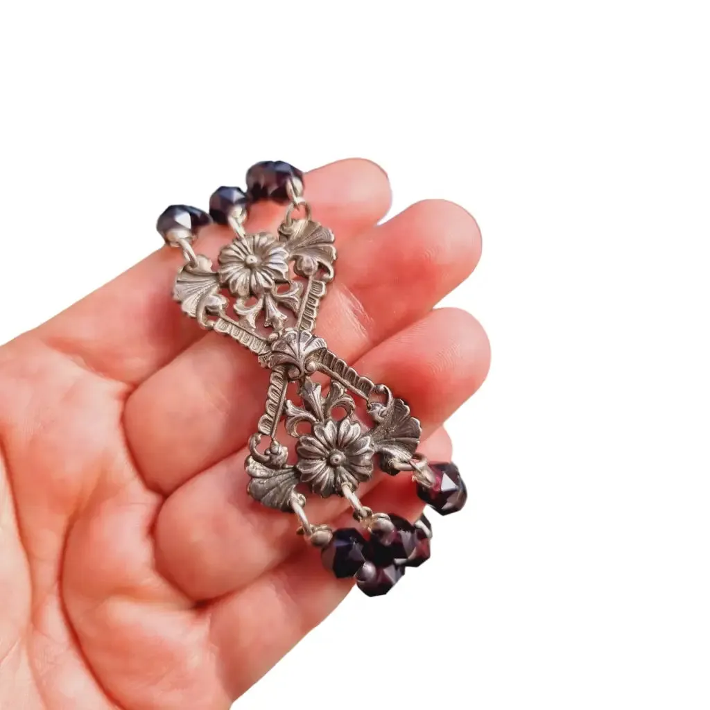 Antique silver modernist bracelet, floral motif and garnet glass beads.