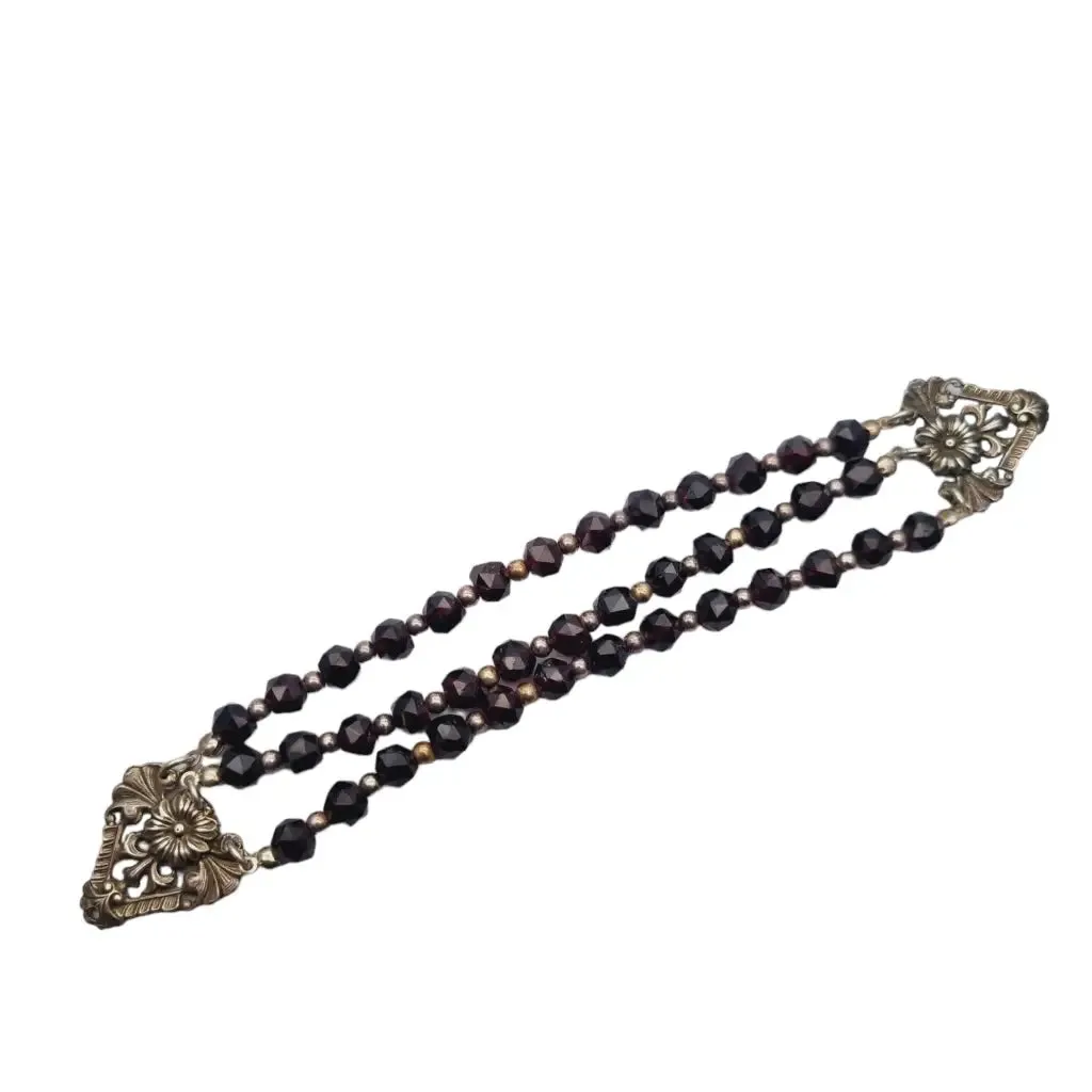 Antique silver modernist bracelet, floral motif and garnet glass beads.