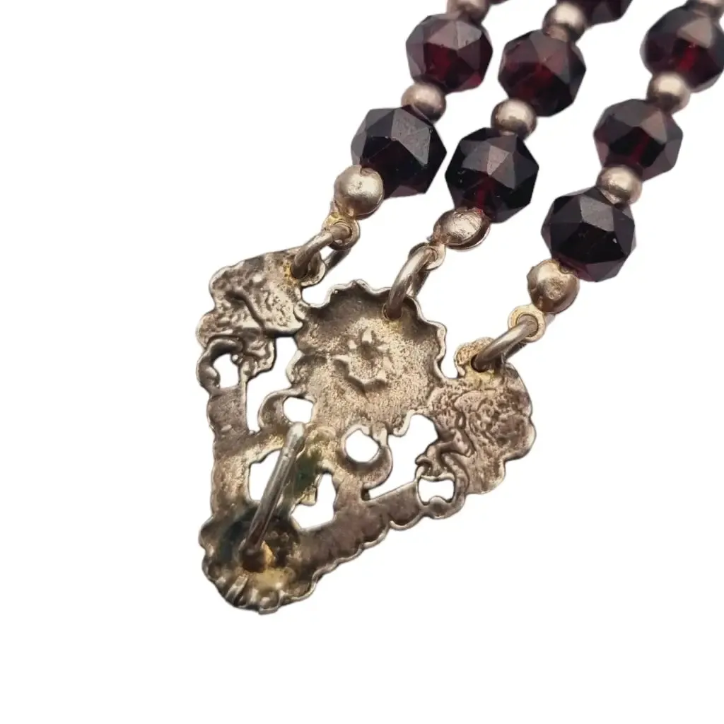 Antique silver modernist bracelet, floral motif and garnet glass beads.
