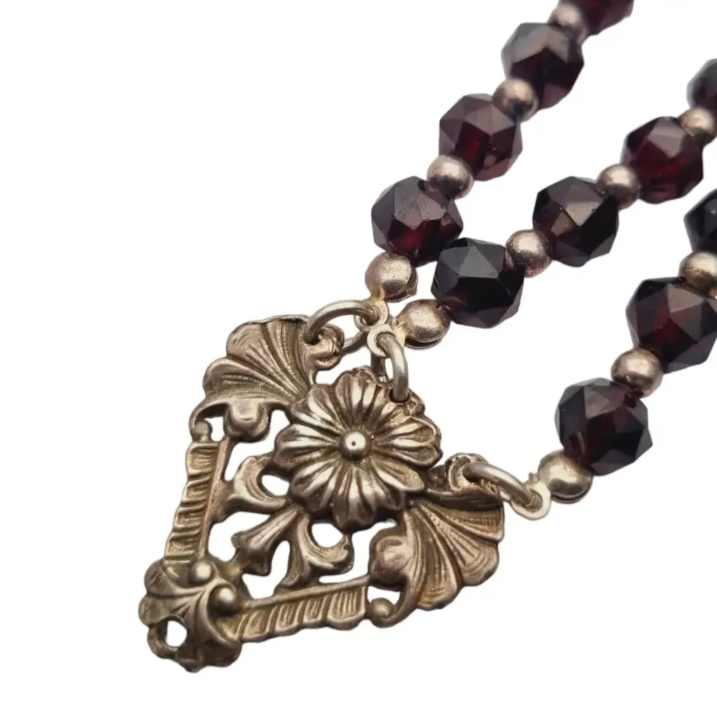 Antique silver modernist bracelet, floral motif and garnet glass beads.